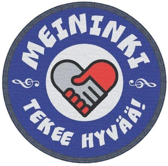Sininen ympyrä jonka ulkokehällä lukee valkoisin isoin kirjaimin Meininki tekee hyvää. Ympyrän keskellä sydän joka muodostuu harmaasta ja punaisesta kättelevästä sydämestä